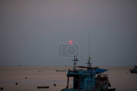 Photo for Fishing boat with greece flag, beautiful sunrise on background - Royalty Free Image