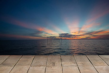 Photo for Beautiful Wood Floor And Sea And Sky BackgroundThe morning sea and the sun shine in the middle of the sea - Royalty Free Image