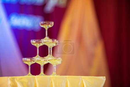 Photo for Empty wine glasses stacked on top of each other. on the table at the wedding Set up a place for celebrations. - Royalty Free Image