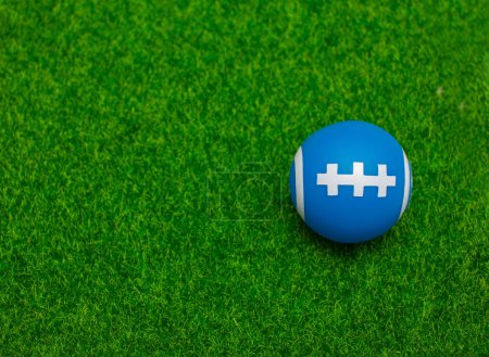 Photo for Ball for American football on fresh green field grass, top view. Space for text - Royalty Free Image
