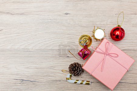 Photo for Christmas cluster high angle view gift boxes presented on rustic wooden floor. Gifts are scattered along the edges of the frame, leaving some space in the middle for your object or copy. - Royalty Free Image