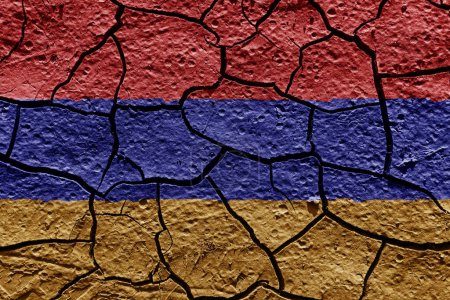 Téléchargez les photos : Armenia flag on a mud texture of dry crack on the ground - en image libre de droit