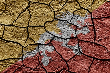 Téléchargez les photos : Bhutan flag on a mud texture of dry crack on the ground - en image libre de droit