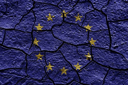 Téléchargez les photos : European Union flag on a mud texture of dry crack on the ground - en image libre de droit