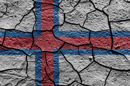 Téléchargez les photos : Faroe Islands flag on a mud texture of dry crack on the ground - en image libre de droit