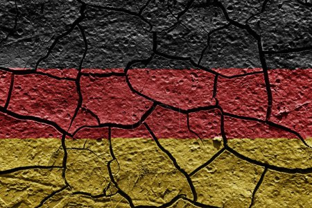 Téléchargez les photos : Germany flag on a mud texture of dry crack on the ground - en image libre de droit