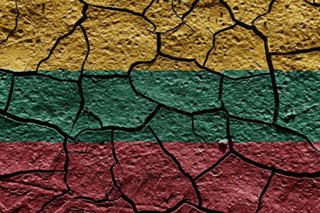 Téléchargez les photos : Lithuania flag on a mud texture of dry crack on the ground - en image libre de droit