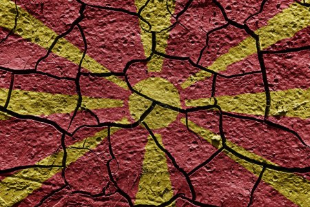 Téléchargez les photos : Macedonia flag on a mud texture of dry crack on the ground - en image libre de droit