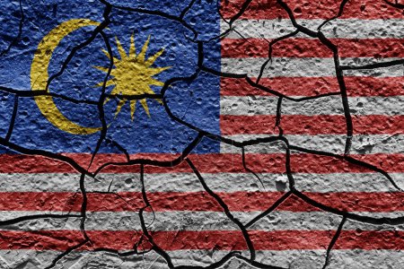 Téléchargez les photos : Malaysia flag on a mud texture of dry crack on the ground - en image libre de droit