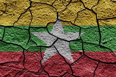 Téléchargez les photos : Myanmar flag on a mud texture of dry crack on the ground - en image libre de droit