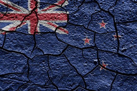 Téléchargez les photos : New Zealand flag on a mud texture of dry crack on the ground - en image libre de droit