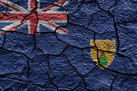 Téléchargez les photos : Turks and Caicos Islands flag on a mud texture of dry crack on the ground - en image libre de droit