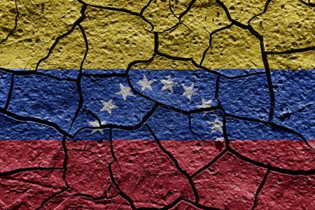 Téléchargez les photos : Venezuela flag on a mud texture of dry crack on the ground - en image libre de droit