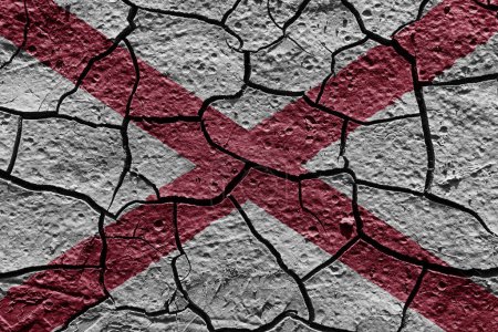 Téléchargez les photos : Alabama state flag of United States on a mud texture of dry crack on the ground - en image libre de droit