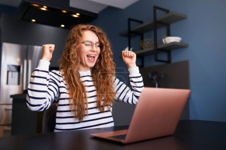 Female rejoice, celebrate bank loan acception, big lottery win, auction victory, profitable bet on a crypto stock market. Woman checks e-mail, news about success on laptop, happily throws up papers.