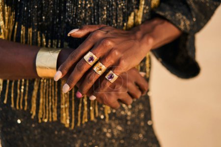 Photo for Gender fluid biracial gay hands with jewelry rings, bracelets. Bipoc trans model poses with manicure in closeup. Androgynous drag person touches hands tenderly. Pride. Transgender shows his identity. - Royalty Free Image