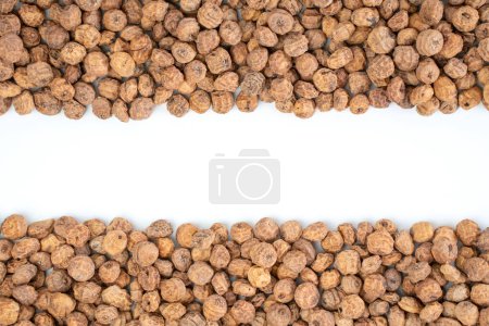 Photo for Studio shot of top view of a bunch of tiger nuts on a white background with copy space in the middle - Royalty Free Image