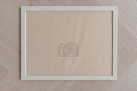 Photo for Top view of empty blank space of white photo frame, putting on wooden floor. - Royalty Free Image