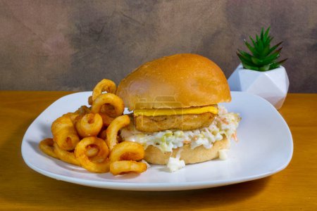 Photo for Fish fillet sandwich  served with curley fries, - Royalty Free Image