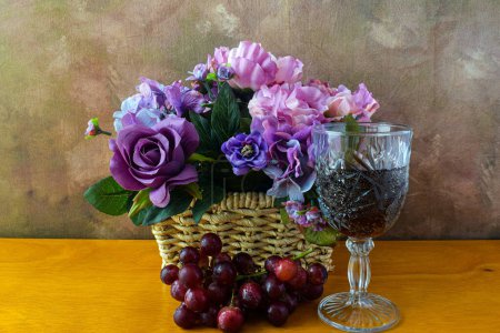 Photo for Wet grapes with a glass of wine  and a flower box - Royalty Free Image