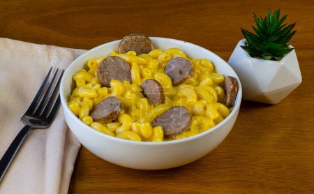 bowl of macaroni cheese top with italian sausage