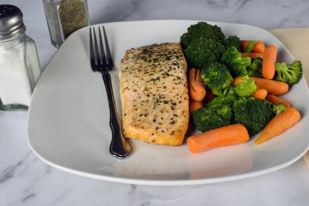 Photo for Baked season salmon with a side of  broccoli and carrots, - Royalty Free Image