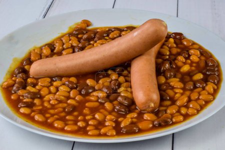 Photo for Hot dogs served with baked beans on a plate - Royalty Free Image