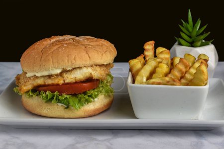 Photo for Baked haddock sandwich  served with french fries - Royalty Free Image