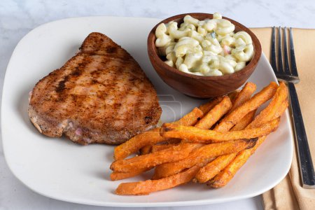 Photo for Tuna steak season with pepper gaslic salt and paprika served with  sweet potato fries, - Royalty Free Image