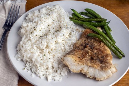 baked cod with  rice top with parsley  served with green beans