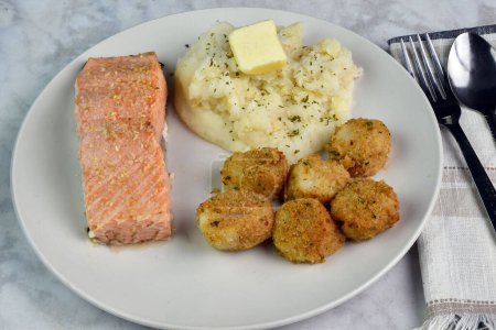 Photo for Baked salmon top with garlic salt and onion salt served with scallops and mashed potatoes - Royalty Free Image