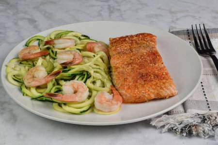 Photo for Seasoned salmon served with zucchini noodles top with shrimp - Royalty Free Image