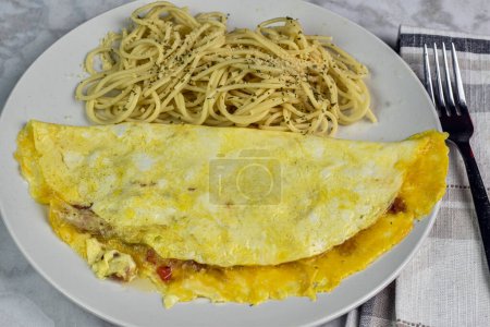 an western omelette   served with spaghetti top with cheese and parsley