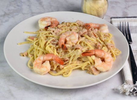 linguine  with alfredo sauce and served with minced clam and shrimp,