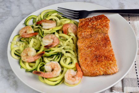 Photo for Baked season salmon served with zucchini noodle  and shrimp., - Royalty Free Image