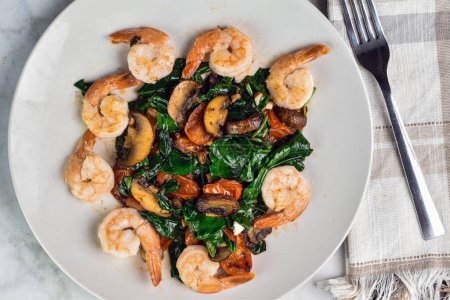  dish of sauteed spinach,  tomatoes and mushrooms served with  shrimp