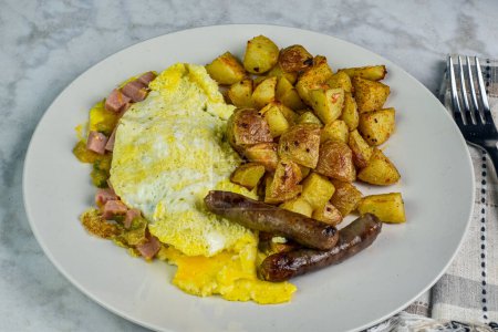 spam western omelette served with home fries and breakfast sausage.