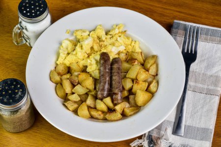 scramble eggs served with home fries and sausages