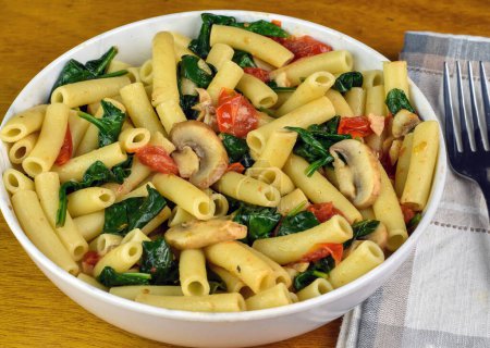 ziti served with sauteed spinach , tomatoes and mushrooms