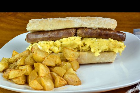 scramble egg  with sausage  on ciabatta served with  home fries, 