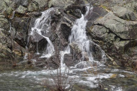 water cascading over  rocks at the spillway of the quabbin reservoir