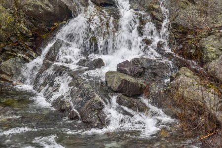 water cascading over  rocks at the spillway of the quabbin reservoir