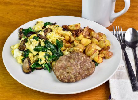 scramble eggswith sauteed spinach and mushrooms served with sauage patty and home fries