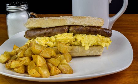 scramble egg  with sausage  on ciabatta served with  home fries,