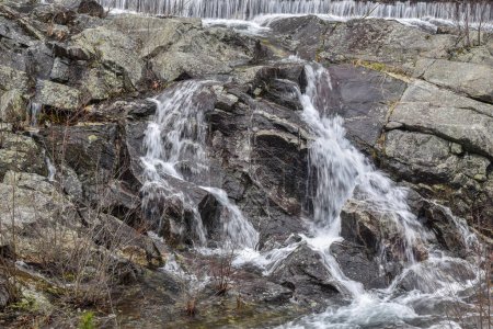 water flowing   over the  rocks at the spillway of the quabbin reservoir