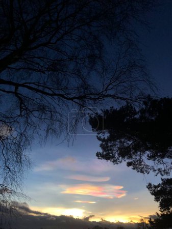 Nacreous or polar stratospheric cloud in North Yorkshire, England, United Kingdom. Nacreous clouds form in the lower stratosphere over polar regions when the sun is just below the horizon. The clouds are illuminated from below and often glow in vivid