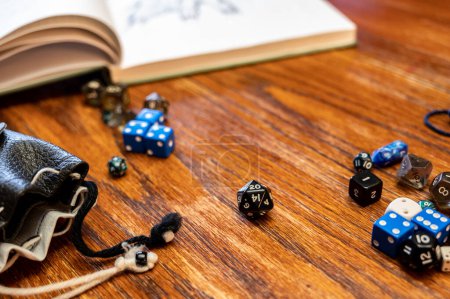 Photo for Multiple gaming dice on wooden table used for role playing adventures. High quality photo - Royalty Free Image