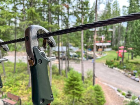 Photo for Selective focus on a safety clip used on a high wire ropes course . High quality photo - Royalty Free Image