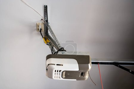 Image d'installation ou de réparation d'une boîte de moteur de porte de garage avec chaîne étendue.