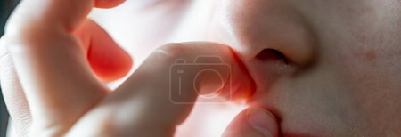 Photo for Selective focus on a Caucasian child picking their nose and eating the boogers . High quality photo - Royalty Free Image